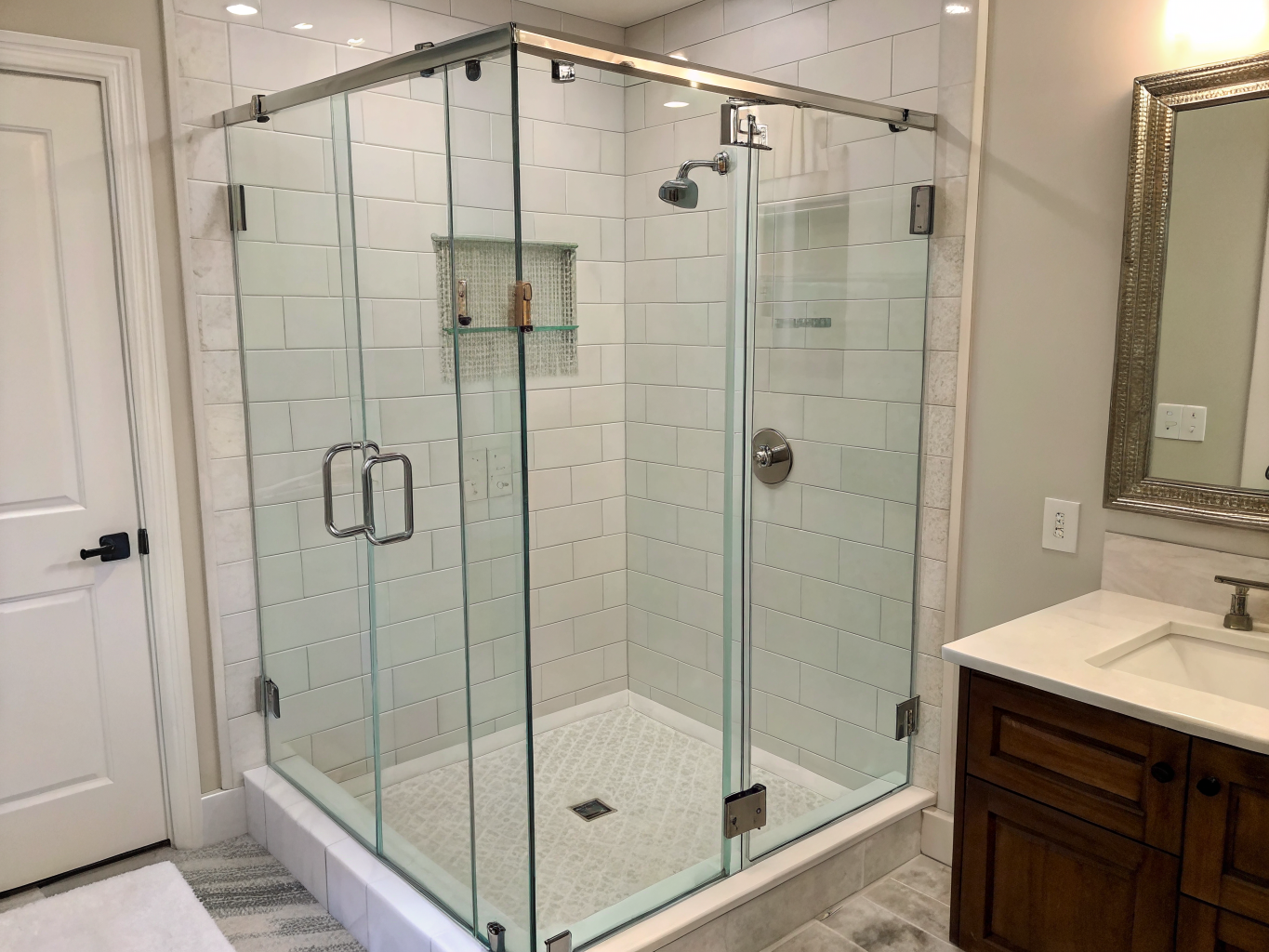 Frameless glass shower enclosure with subway tile in Chicago bathroom