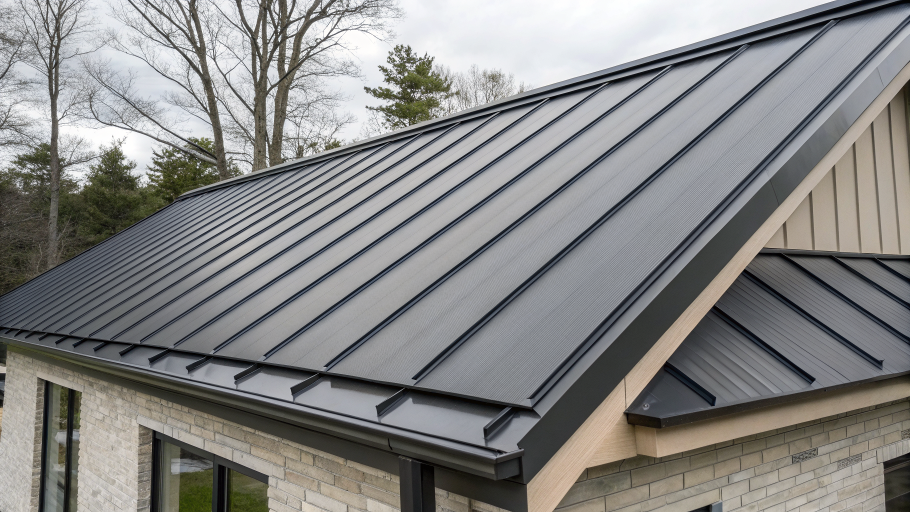 Standing seam metal roofing panels in dark charcoal grey
